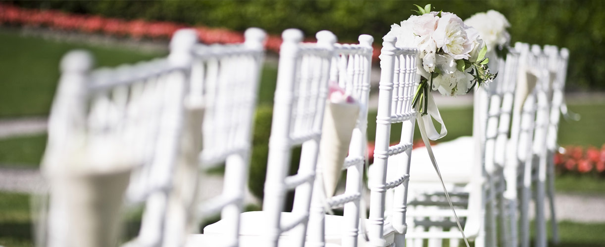 destination wedding white chairs and flowers 3